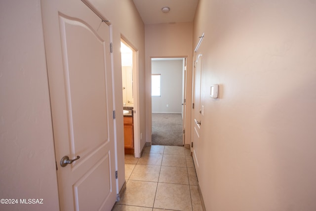 corridor featuring light tile patterned floors