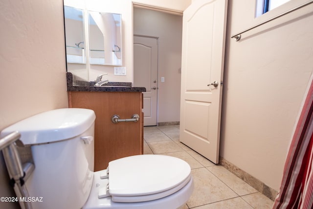 bathroom with tile patterned flooring, vanity, and toilet