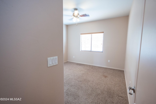 spare room with ceiling fan and carpet floors