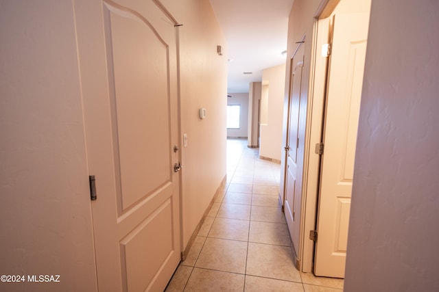 corridor with light tile patterned floors