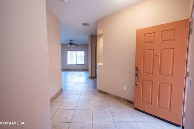 tiled entrance foyer with ceiling fan