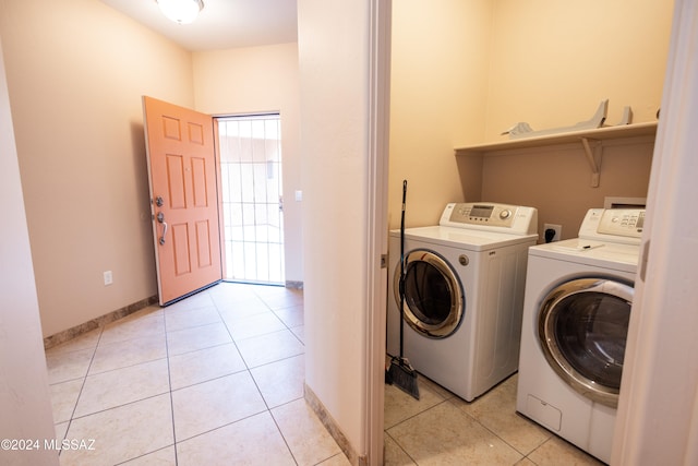 laundry area with washing machine and dryer and light tile patterned flooring