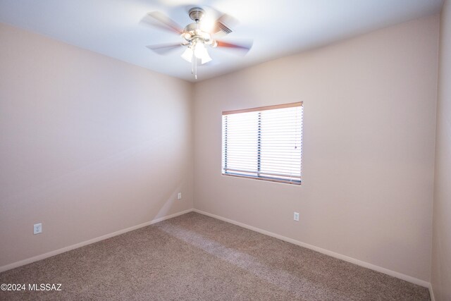 spare room featuring carpet floors and ceiling fan