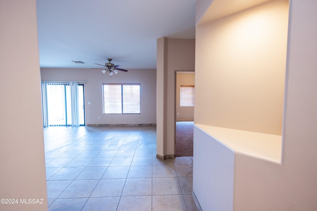 interior space with ceiling fan and light tile patterned floors