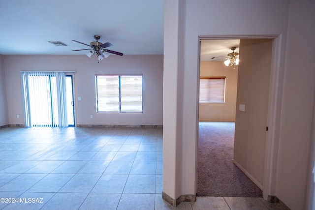 unfurnished room with ceiling fan and light colored carpet