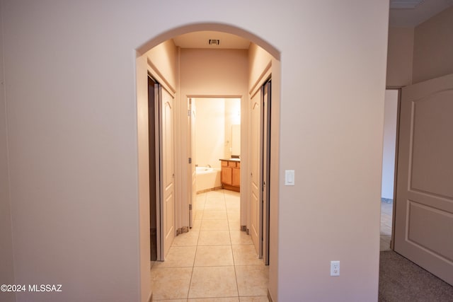 corridor featuring light tile patterned flooring