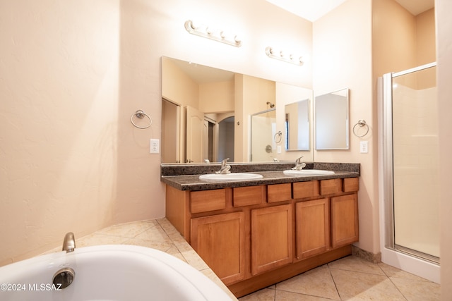 bathroom featuring tile patterned floors, vanity, and separate shower and tub