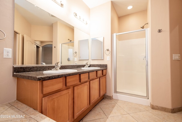 bathroom with tile patterned flooring, vanity, and an enclosed shower