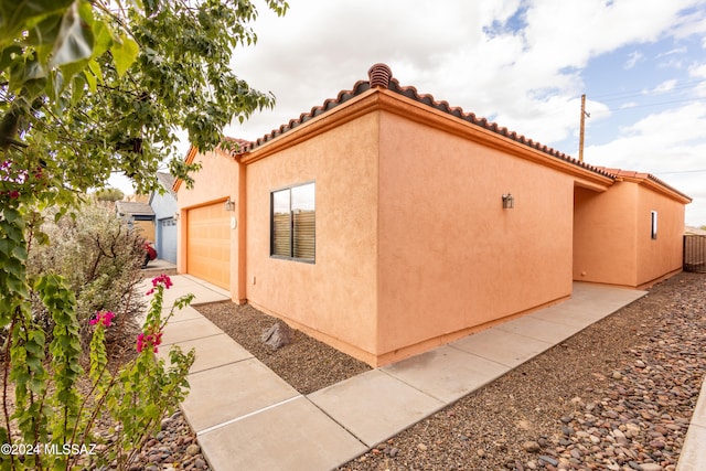 view of side of property featuring a garage