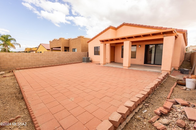 rear view of property with a patio area and central AC unit