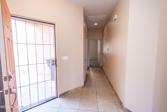 hall featuring light tile patterned floors