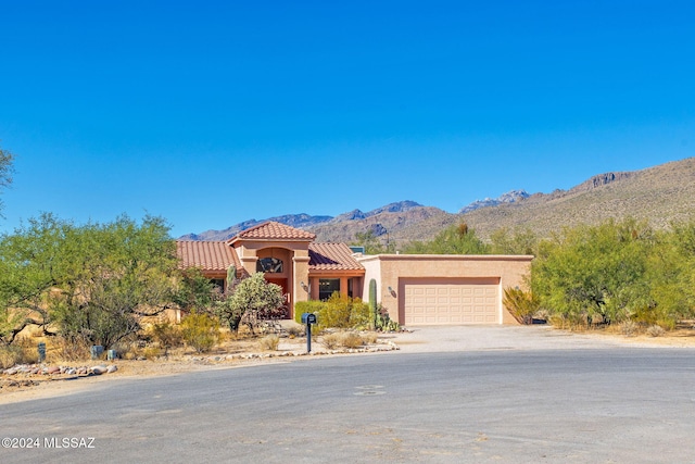 view of front of house featuring a mountain view and a garage