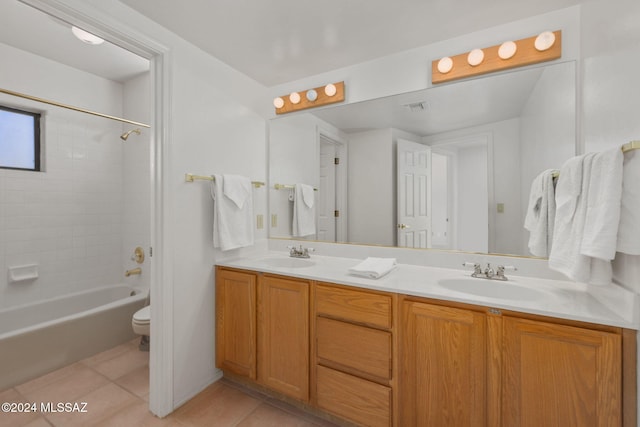 full bathroom with toilet, vanity, tile patterned floors, and tiled shower / bath