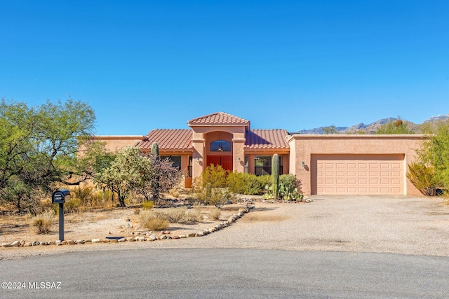 view of front of property featuring a mountain view and a garage