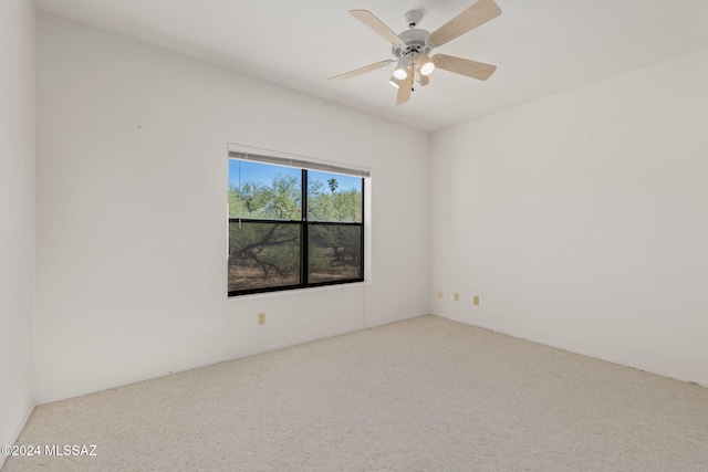 spare room with light carpet and ceiling fan