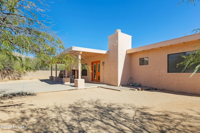 back of property with a patio