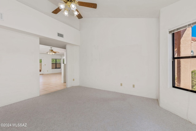 carpeted empty room featuring lofted ceiling