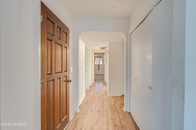 hallway with light hardwood / wood-style floors