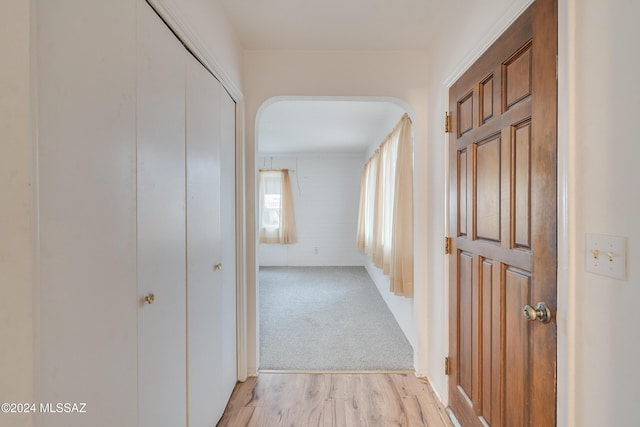 corridor with light hardwood / wood-style flooring