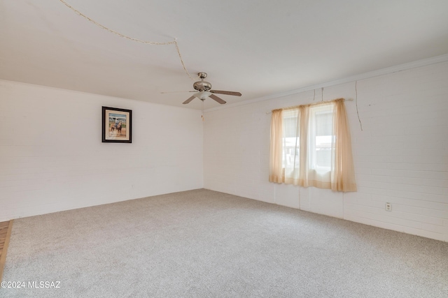 carpeted spare room with crown molding and ceiling fan