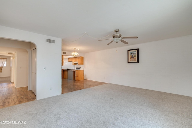 unfurnished living room featuring light carpet and ceiling fan