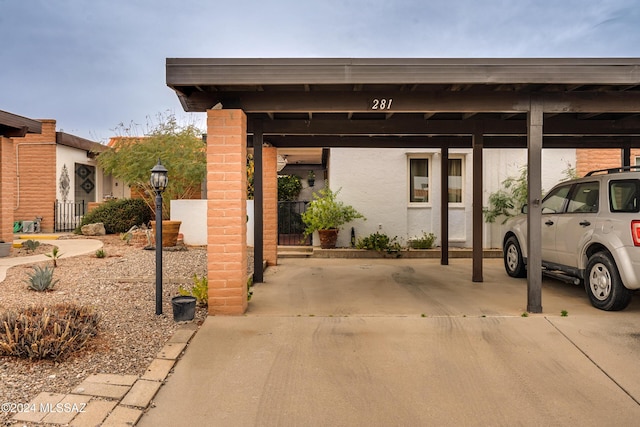 view of vehicle parking featuring a carport