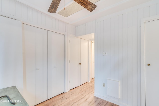 unfurnished bedroom with light wood-type flooring and a closet