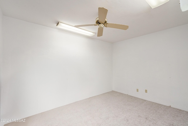 empty room with ceiling fan and carpet flooring