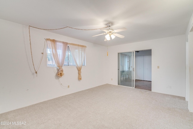 spare room featuring carpet floors and ceiling fan