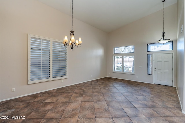 foyer featuring an inviting chandelier and high vaulted ceiling