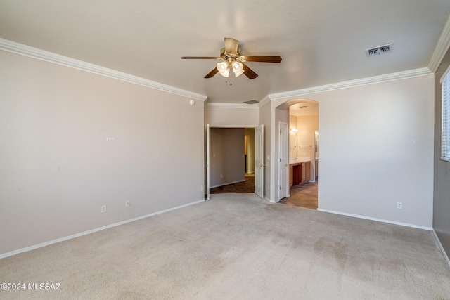 carpeted empty room with crown molding and ceiling fan