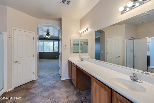 bathroom with ceiling fan, an enclosed shower, and vanity