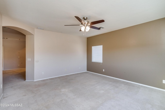 carpeted spare room featuring ceiling fan