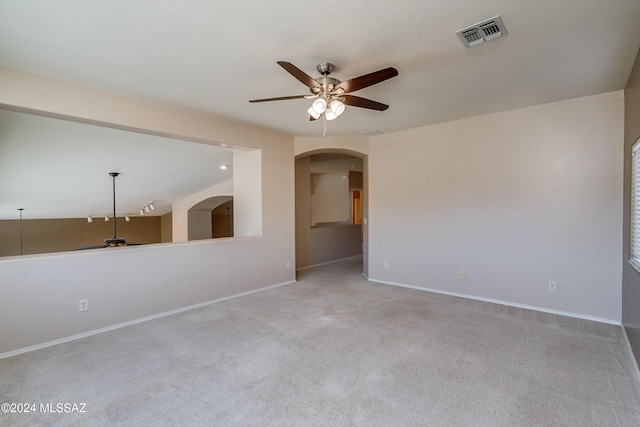 unfurnished room featuring light carpet and ceiling fan