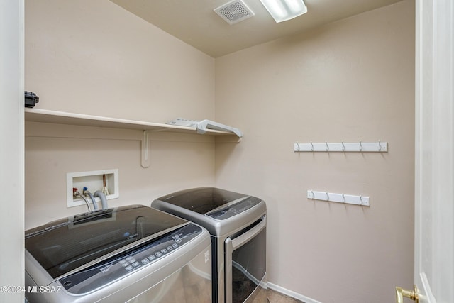 laundry area with washing machine and clothes dryer