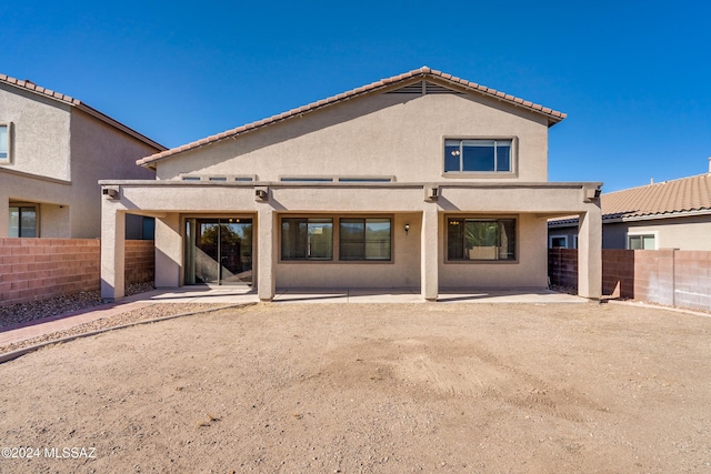 back of property with a patio