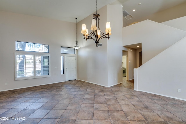 entrance foyer featuring a towering ceiling and a chandelier