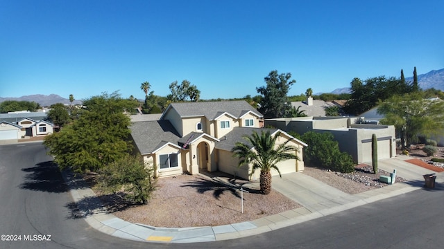 view of front of home with a mountain view and a garage