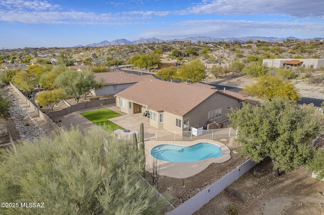 view of swimming pool with a mountain view and a patio area