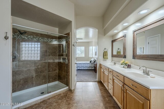 carpeted bedroom with ceiling fan and ensuite bath