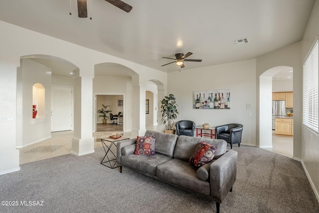 living room featuring light carpet and ceiling fan