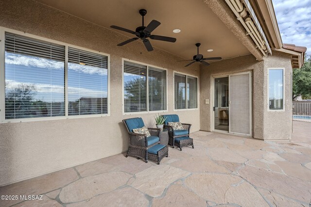 back of house with ceiling fan and a patio