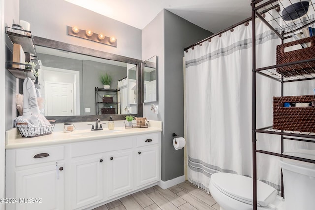 bathroom featuring toilet and vanity