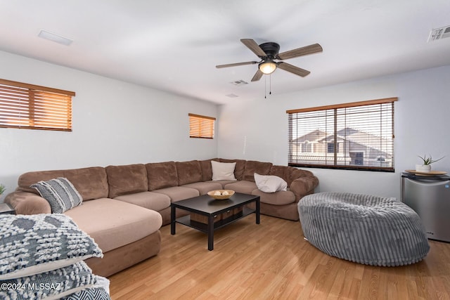 living room with ceiling fan and light wood-type flooring