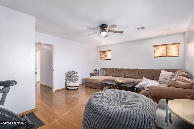 living room with ceiling fan and hardwood / wood-style floors