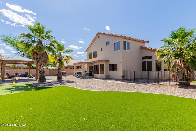 rear view of property with a patio area and a gazebo