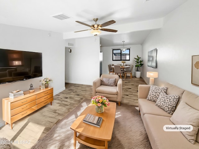 living room with vaulted ceiling with beams, ceiling fan, and light hardwood / wood-style flooring