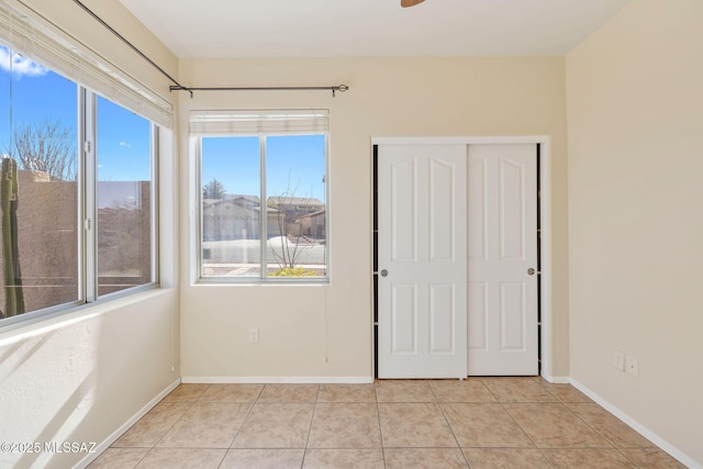 unfurnished room featuring light tile patterned flooring