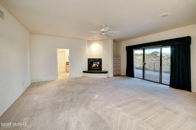 unfurnished living room featuring ceiling fan and light carpet