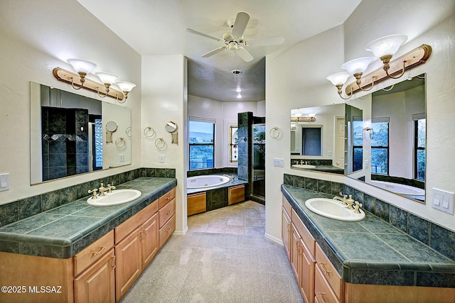 bathroom featuring vanity, ceiling fan, and separate shower and tub